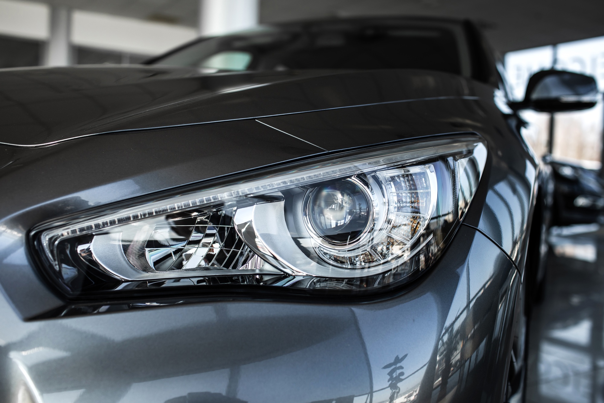 Modern luxury car close-up. Concept of expensive, sports auto. Headlight lamp of new cars